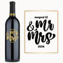 A wine bottle with August 12 & Mr & Mrs 2024 engraved in bold black and gold script on the label.