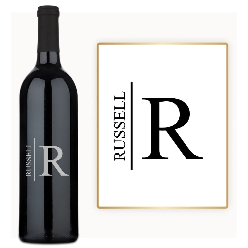 Custom wine bottle engraved with RUSSELL next to a matching black and white framed print.