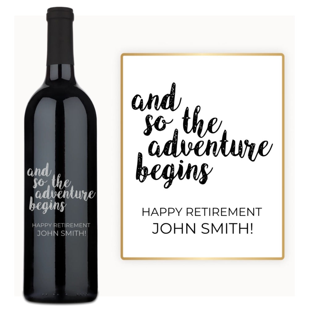 A custom-engraved wine bottle labeled Retirement Adventure Begins with a card saying Happy Retirement, John Smith.