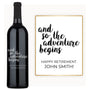 A custom-engraved wine bottle labeled Retirement Adventure Begins with a card saying Happy Retirement, John Smith.