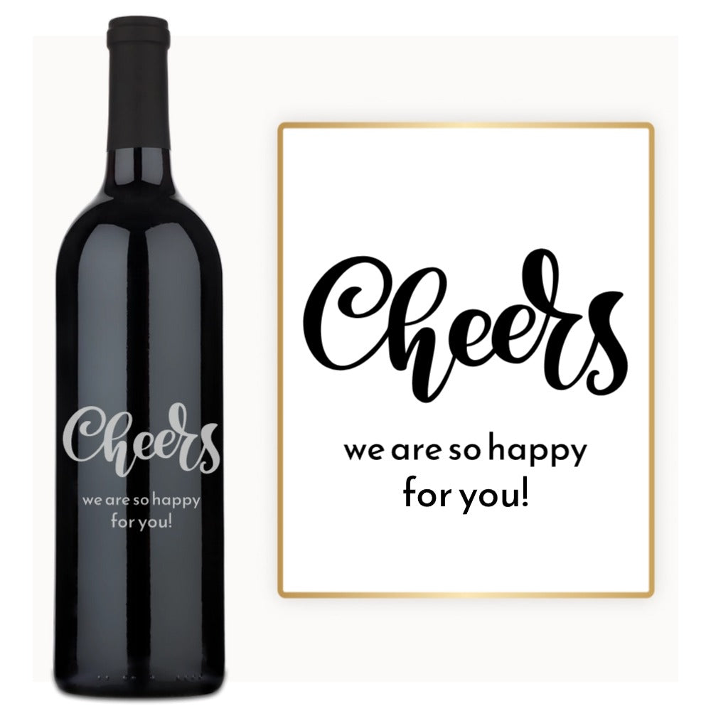 A bottle of red wine with a custom engraved label reading Cheers to You, displayed against a simple background.