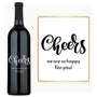 A bottle of red wine with a custom engraved label reading Cheers to You, displayed against a simple background.
