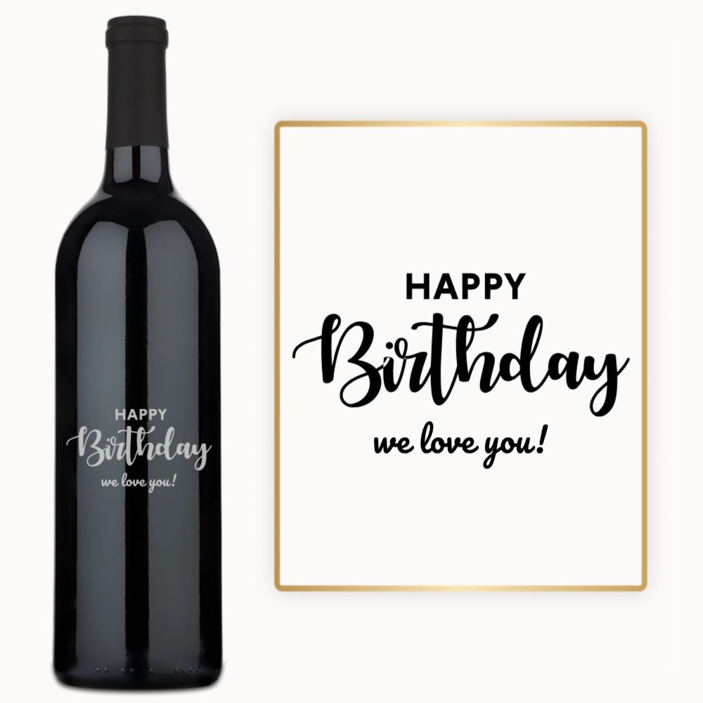 Engraved wine bottle and card, both reading Happy Birthday we love you in black script.