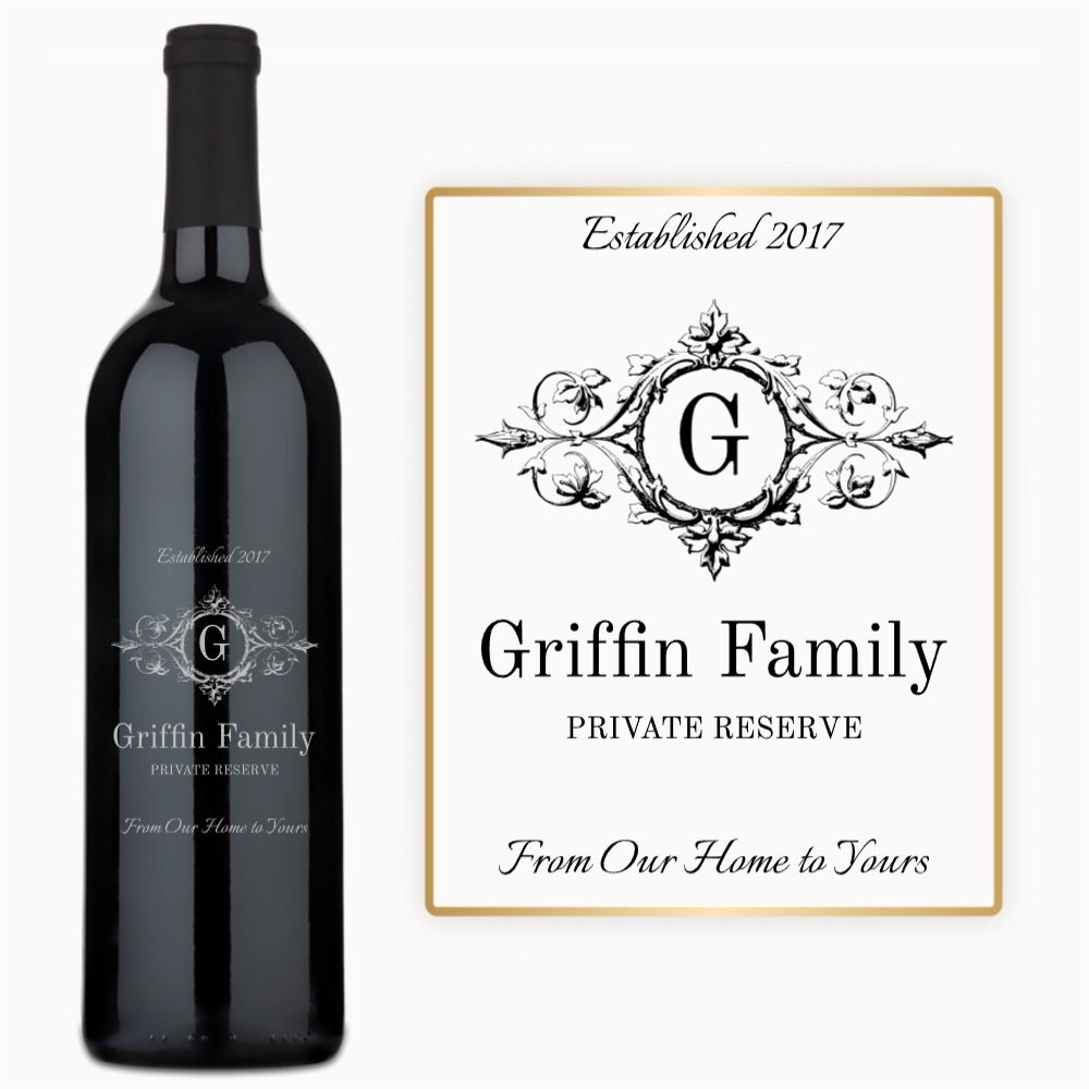 A custom engraved wine bottle sits next to a matching sign displaying the same monogram.