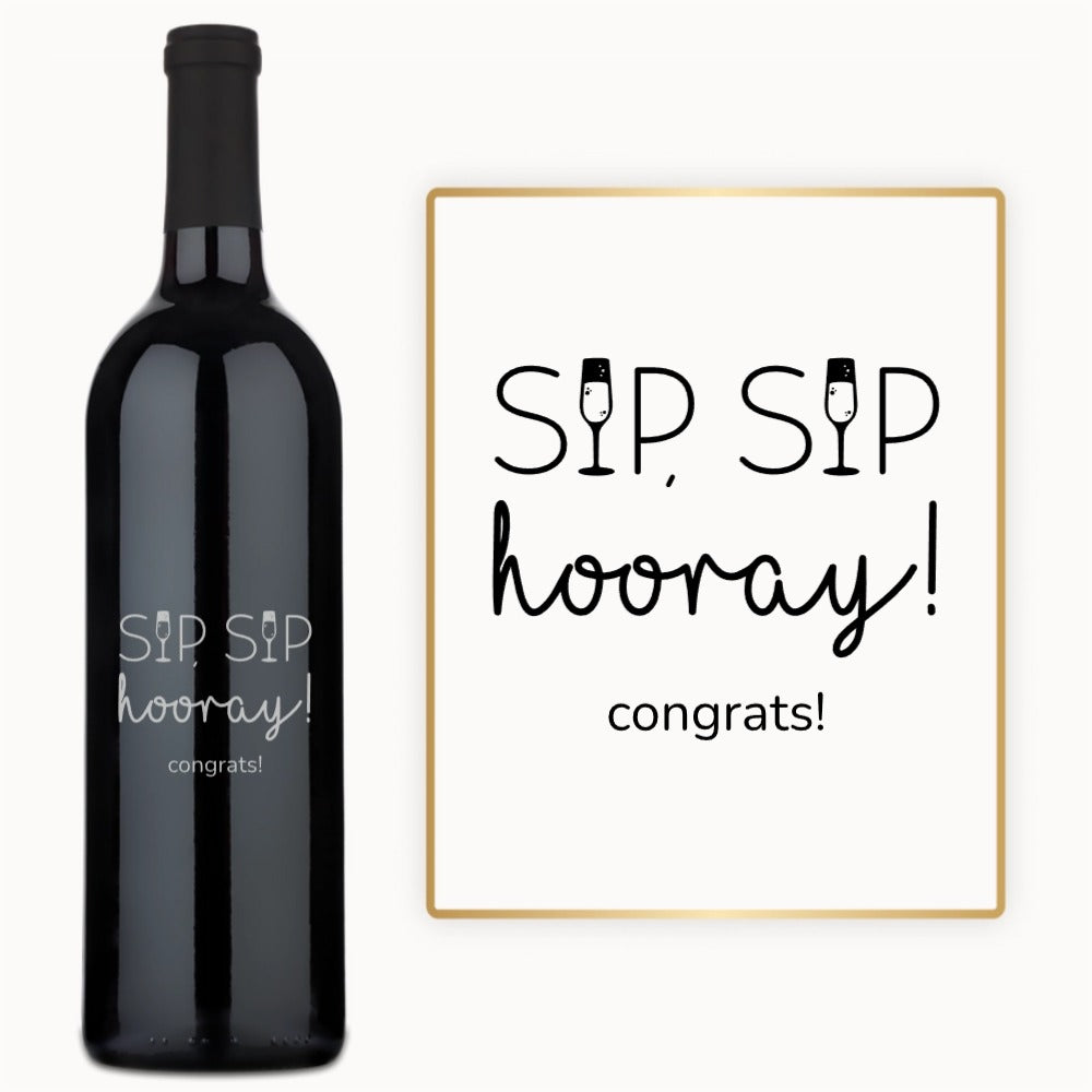 Bottle of wine with Sip Sip Hooray engraved on the label, next to a festive wine glass with decorative art.