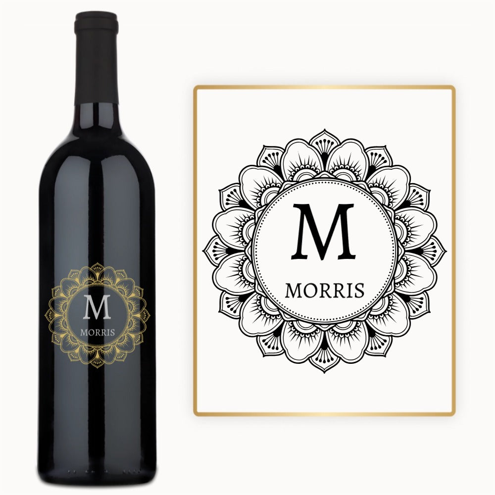 A wine bottle with a black mandala design and the name M MORRIS engraved on the front.