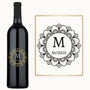 A wine bottle with a black mandala design and the name M MORRIS engraved on the front.