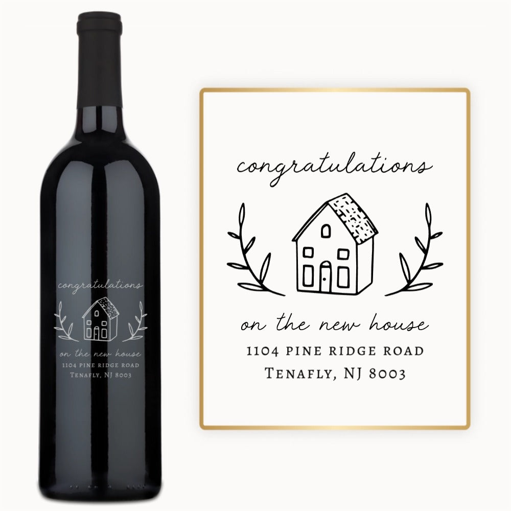 Custom engraved wine bottle labeled Welcome Home with the address 1104 Pine Ridge Rd featured on the design.