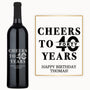 A wine bottle with Happy Birthday Thomas engraved in bold black letters.