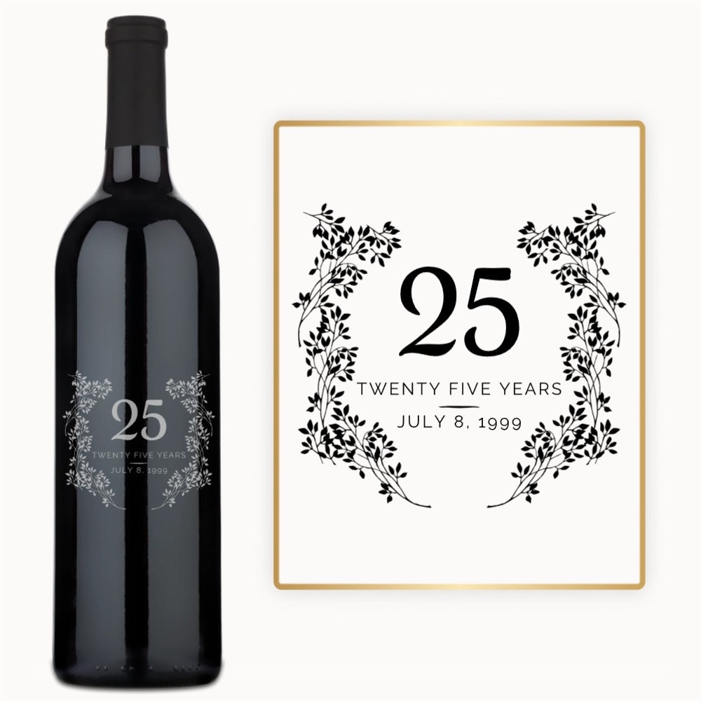 A wine bottle labeled 25 Years July 8, 1999 with a floral wreath design on the front.