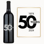 A wine bottle labeled 50 Year Milestone with engraved years 1974–2024 celebrates a 50th anniversary.