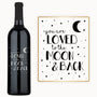 A wine bottle engraved with stars, a crescent moon, and the phrase “You are loved.”.