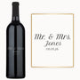 Engraved wine bottle and card displaying Mr. & Mrs. Jones 08.08.26 in elegant script font.