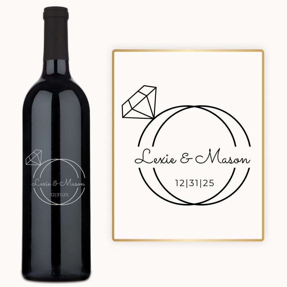 Engraved wine bottle with Lexie & Mason and 12|31|25 in black text, featuring a wedding ring monogram design.