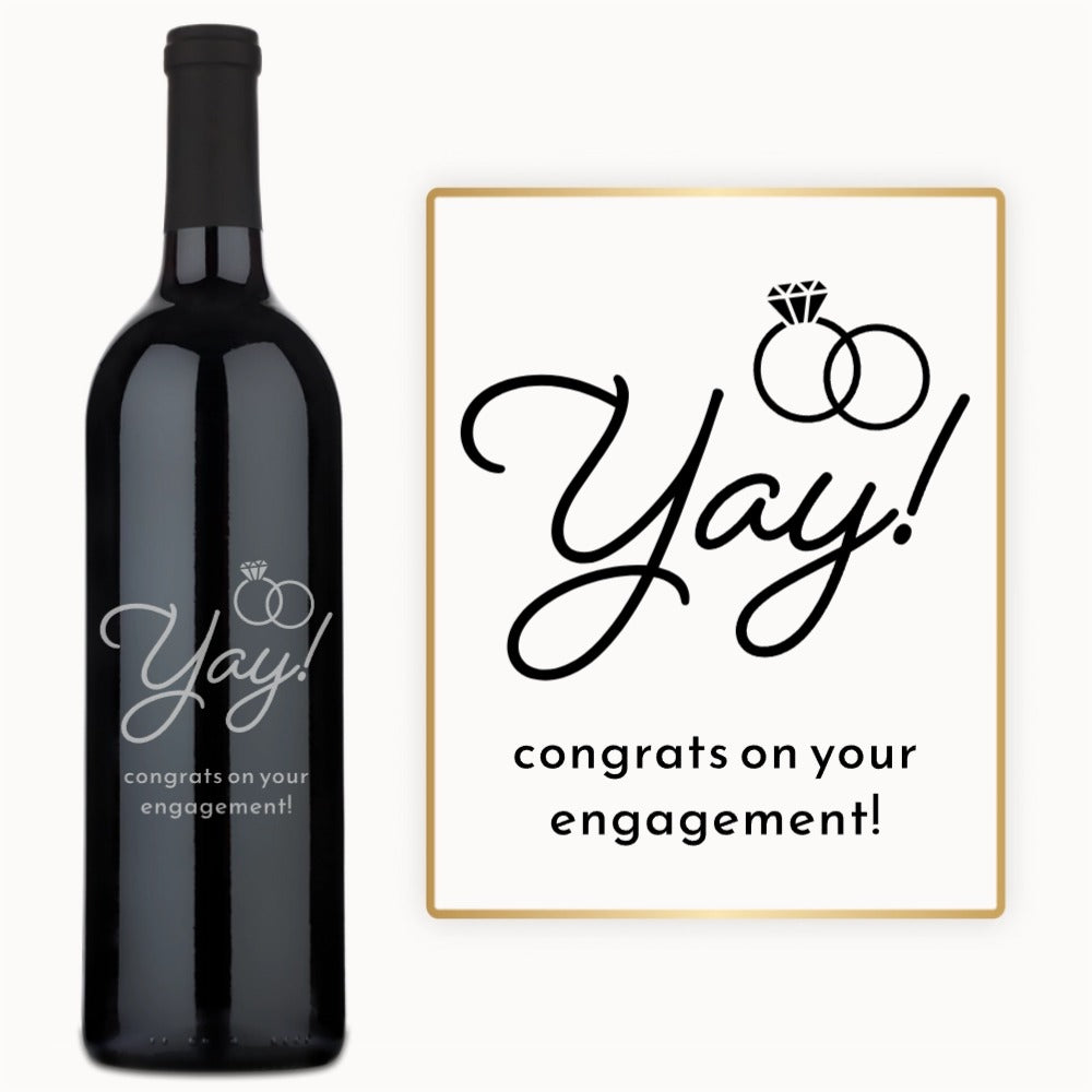 Engraved engagement wine bottle labeled Yay With Rings next to a card reading Yay Congrats on your engagement.