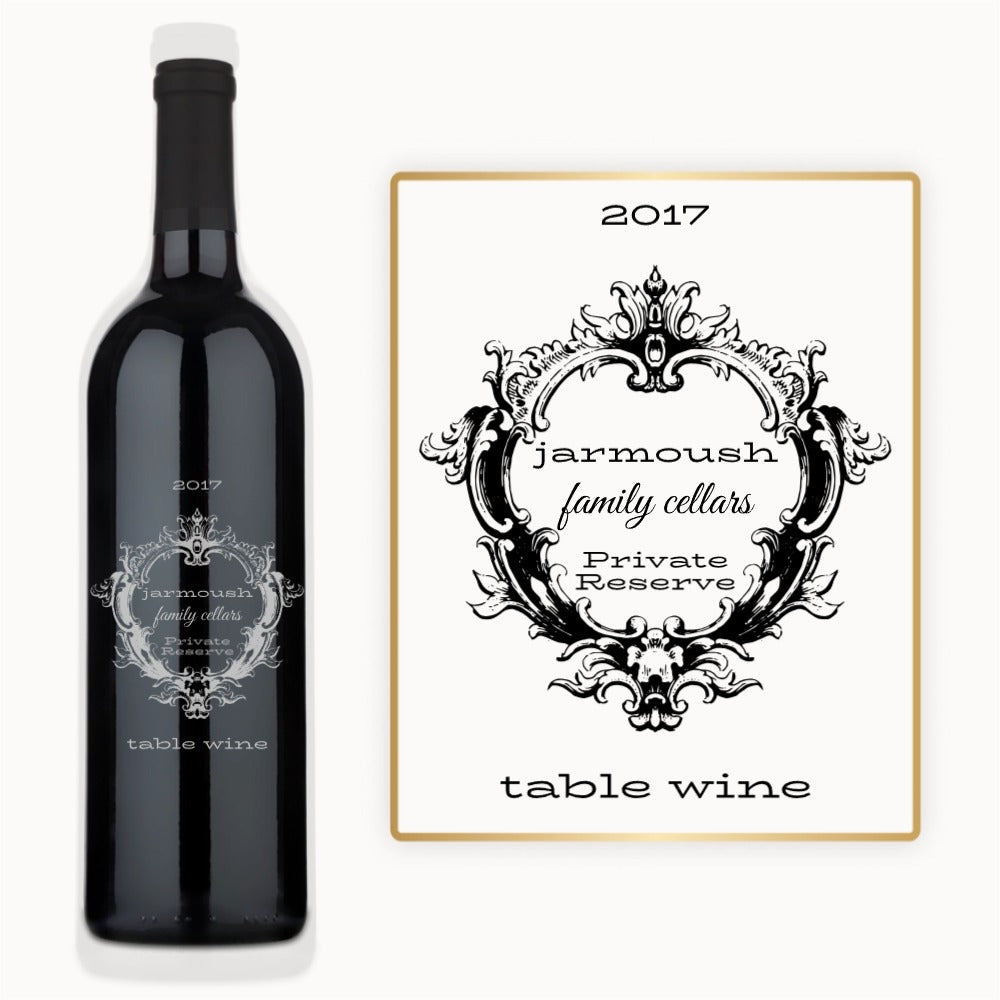 Wine bottle with an ornate black Victorian crest frame and visible custom engraved text on the label.