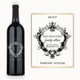 Wine bottle with an ornate black Victorian crest frame and visible custom engraved text on the label.