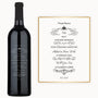 A wine bottle with a vintage-style label displaying elegant engraved text, shown beside a matching decorative card.
