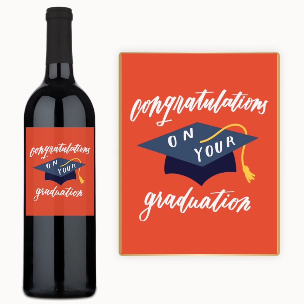 A custom label wine bottle and a graduation card on an orange background.
