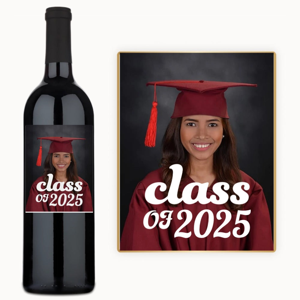 A wine bottle with a custom label showing a smiling graduate in cap and gown, and the class year.