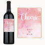 A bottle of Pink Cheers Celebration wine with a custom label and a card that reads, You did it Love, Brit & Sam.