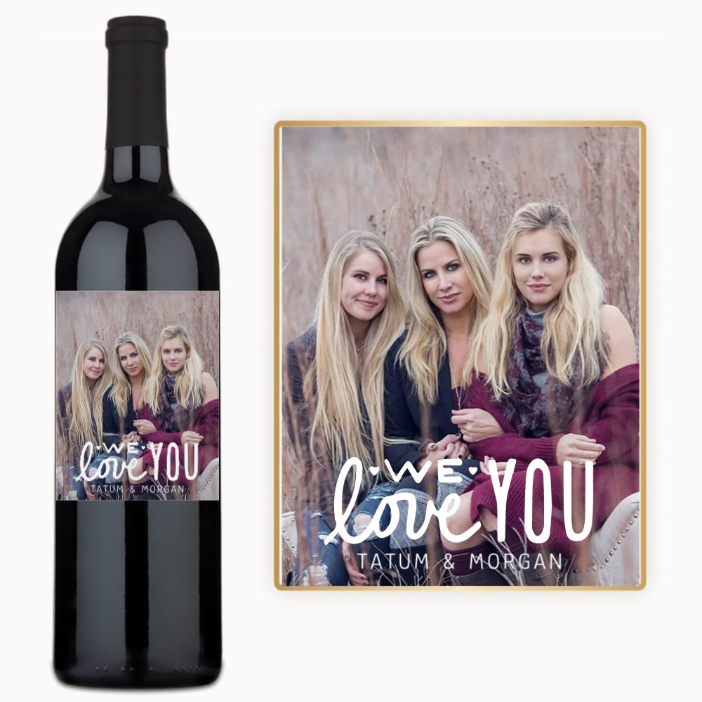 Three women smiling on a wine bottle label with the text, We love you Tatum & Morgan.