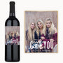 Three women smiling on a wine bottle label with the text, We love you Tatum & Morgan.