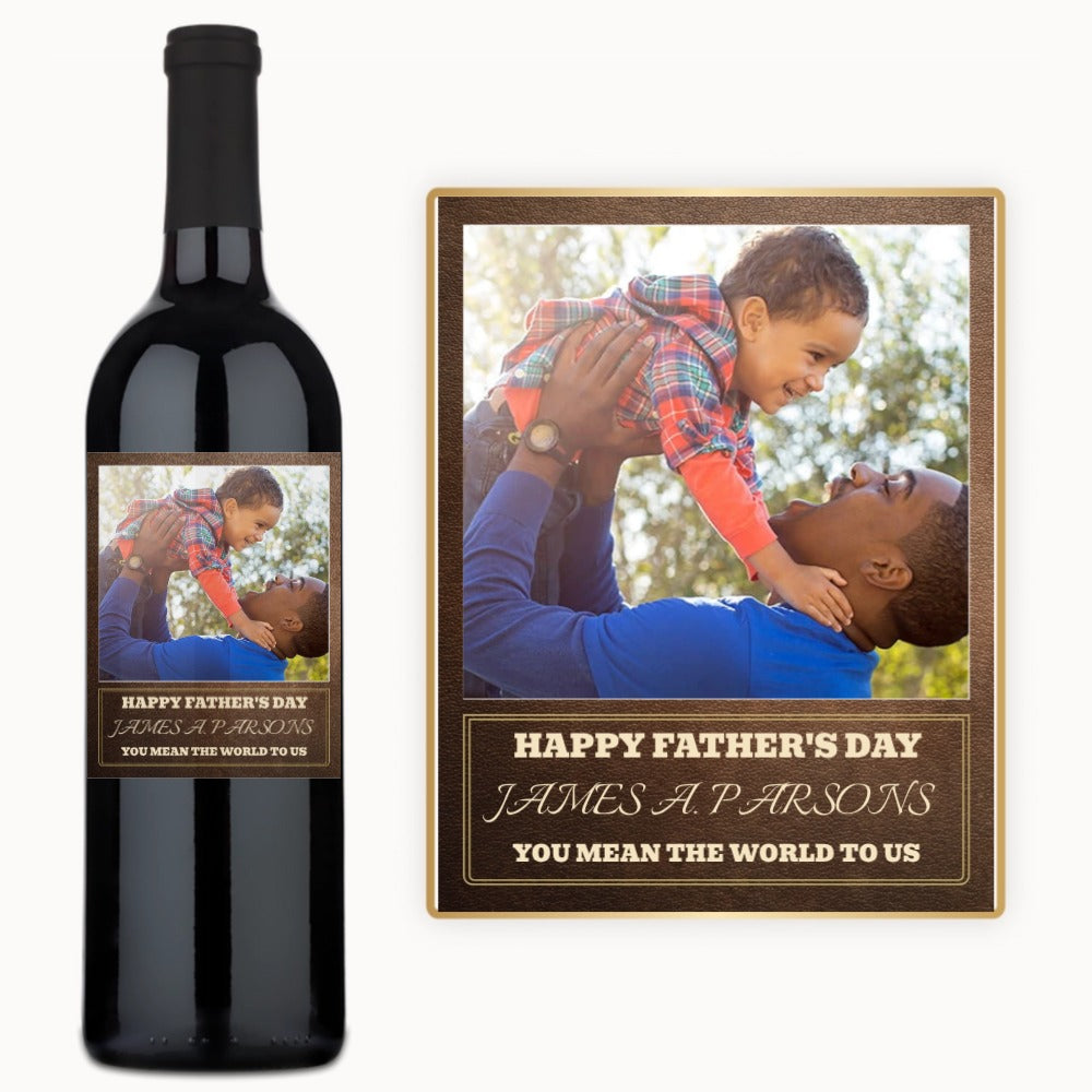 A dad lifts his smiling child on a wine label that reads, Happy Father’s Day, James A. Parsons.