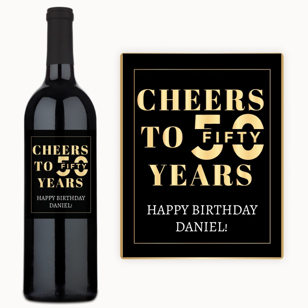 A black birthday wine bottle and sign with Happy birthday Daniel written in gold.