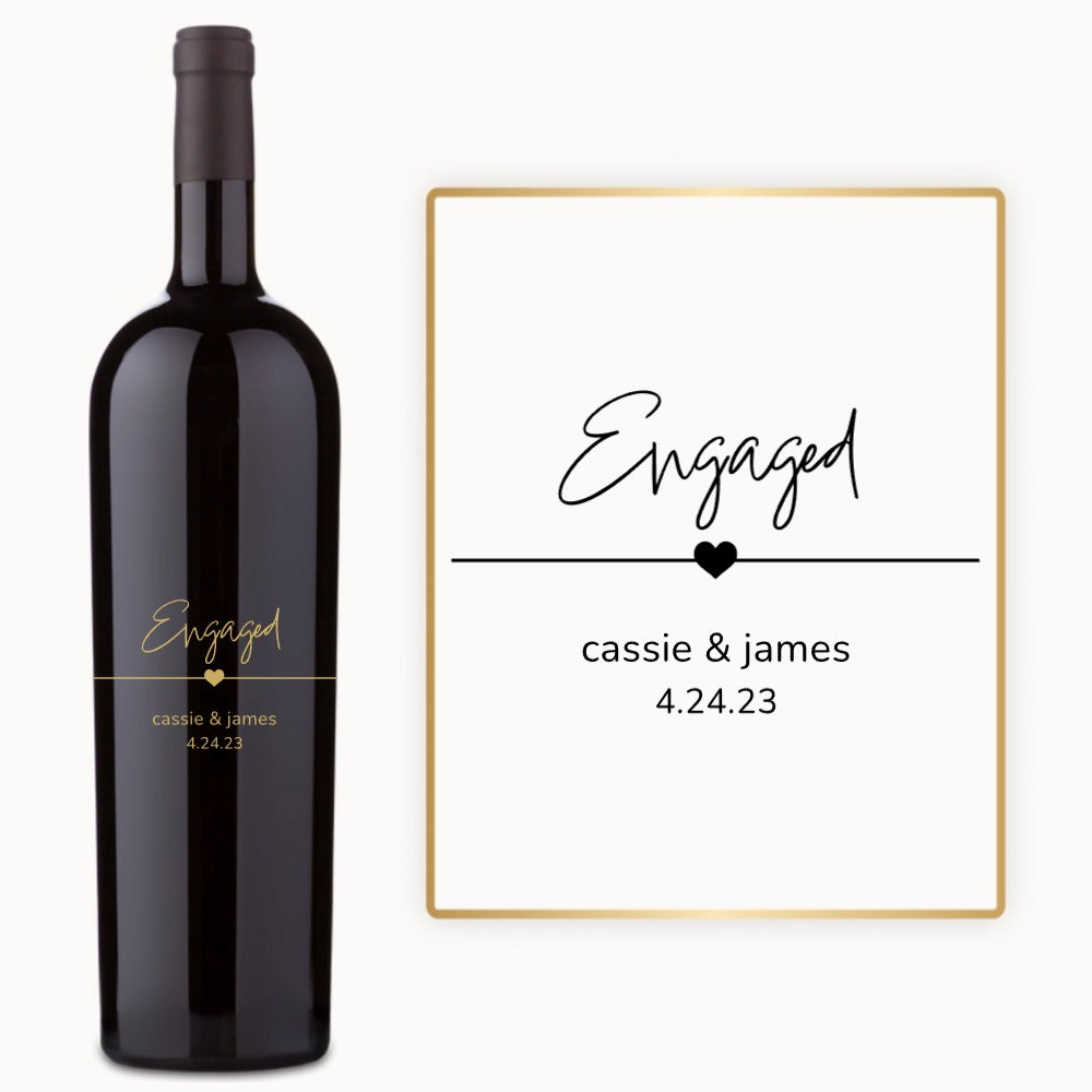 A custom Just Engaged wine bottle next to an engagement card for Cassie & James, dated 4.24.23.