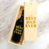Engraved wood wine box reading To the Best Dad Ever, shown on a marble surface.