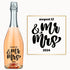A wine bottle labeled Mr & Mrs in bold script with the date 8/12/24 engraved on it.