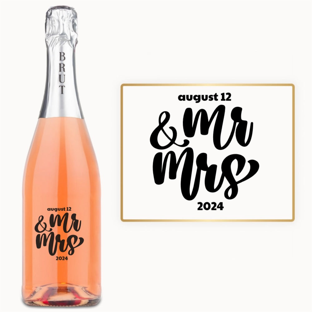 Engraved wine bottle with Mr & Mrs, August 12, and 2024 beside a matching sign displaying the same text.