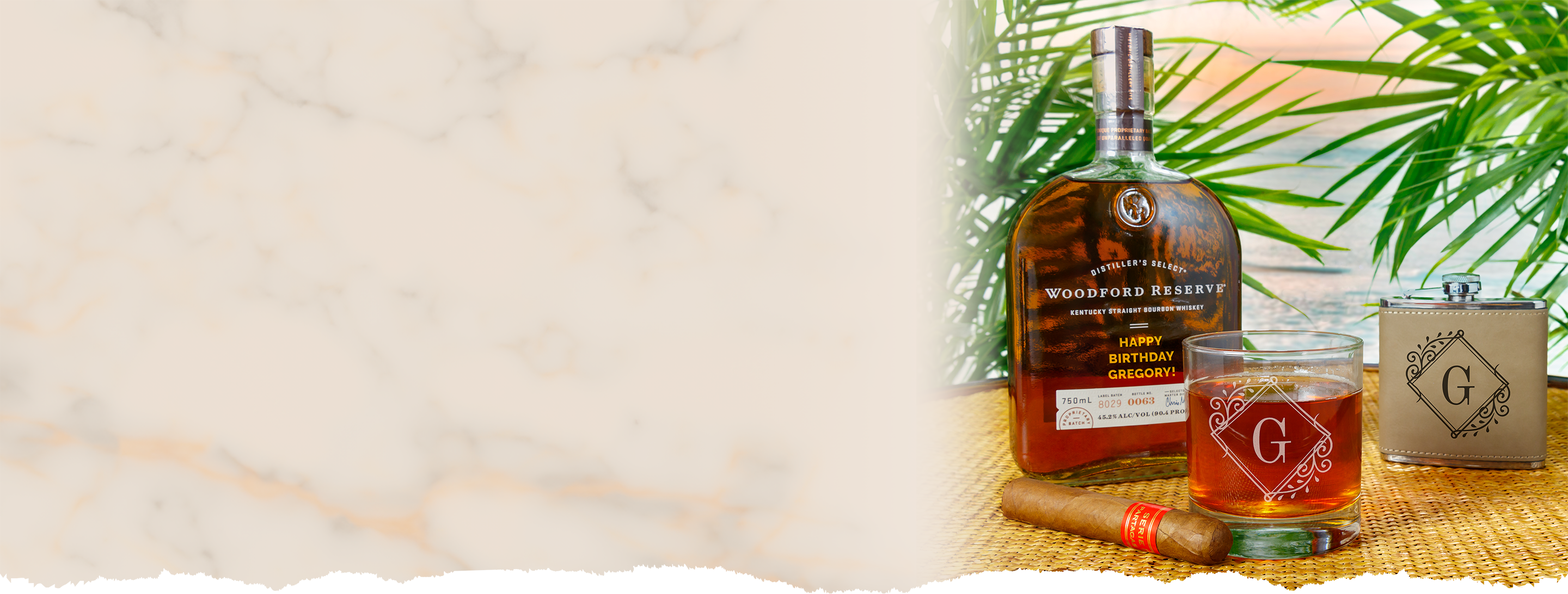 Woodford Reserve bourbon bottle with a glass on a textured surface with greenery in the background