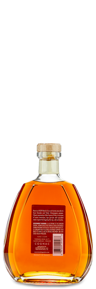 Round bottle of Hine Rare VSOP Cognac with cork stopper and a red label on the back.