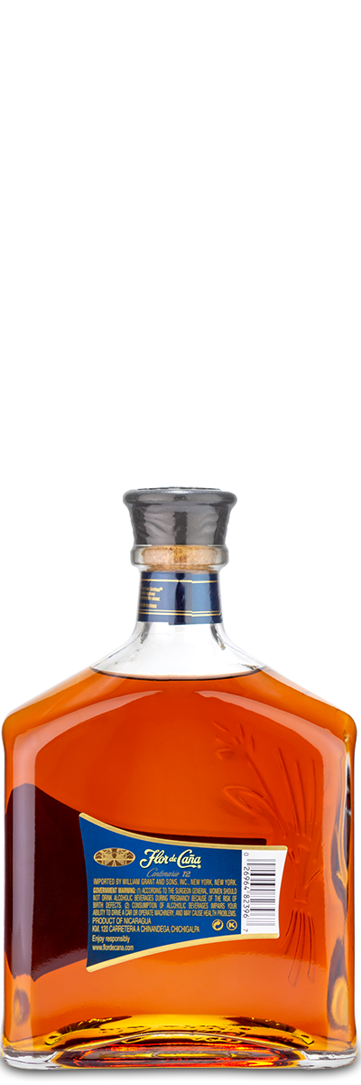 A square FLORDECANA Flor de Cana 12 Year Rum bottle with a silver cap, blue label, and amber liquid inside.