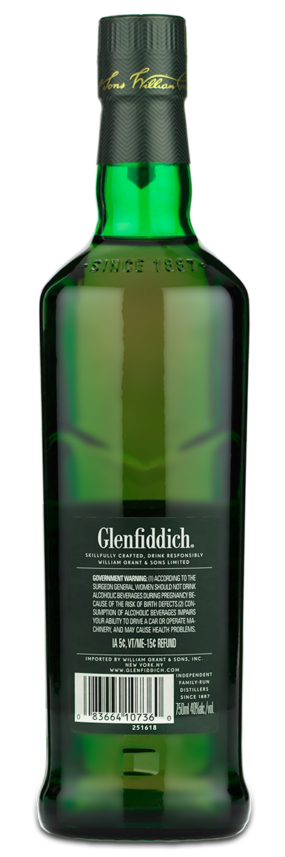 Back of a green glass Glenfiddich 12 Year Scotch bottle with label and barcode visible.