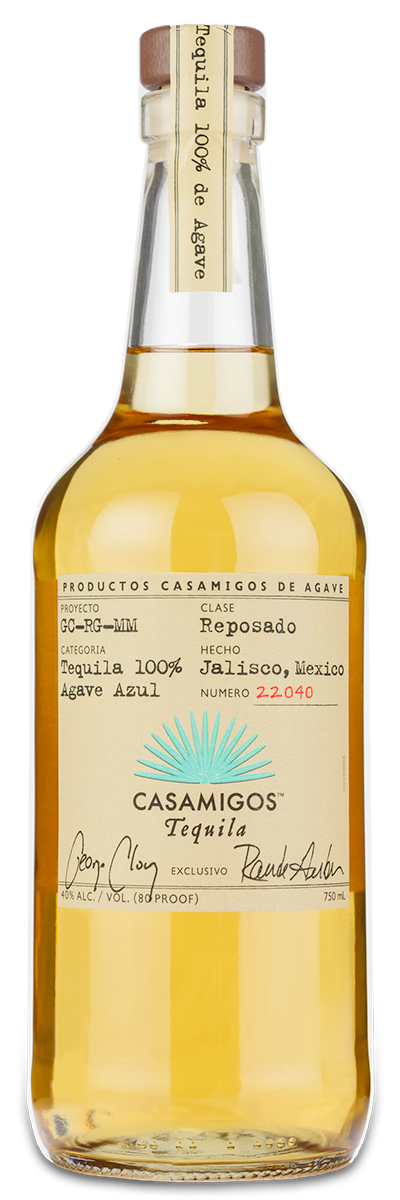 A bottle of Casamigos Tequila Reposado with a custom wine label, gold cap, and pale amber liquid.