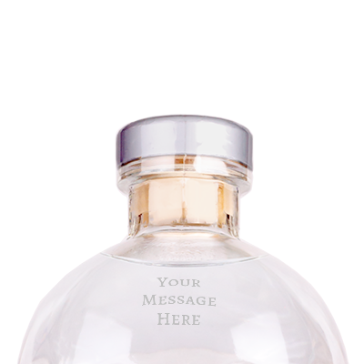Crystal head vodka bottle on a white background with "your message here" engraved on the forehead.