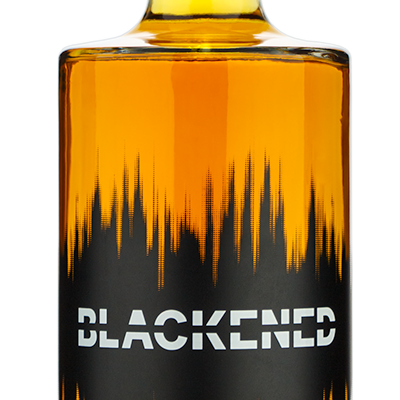 Bottle of Blackened whiskey with it's original distillery front label on a white background.