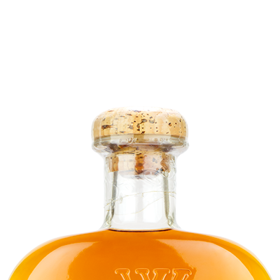 WhistlePig 18 Year Straight Rye Whiskey bottle with cork, filled with amber liquid, on a white background.