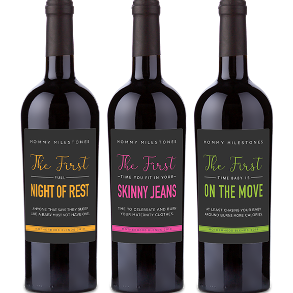 Three wine bottles with labels reading Night of Rest, Skinny Jeans, and On the Move from the Mommy Milestones series.