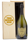 A Dom Perignon Champagne bottle displayed in a custom-engraved wooden wine box.