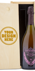 A Dom Perignon Rosé Champagne bottle displayed in a custom engraved wooden wine box.