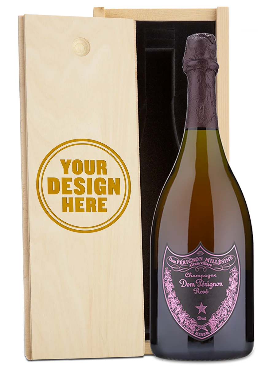 A Dom Perignon Rosé Champagne bottle displayed in a custom engraved wooden wine box.