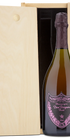 A Dom Perignon Rosé Champagne bottle displayed in a wooden wine box.