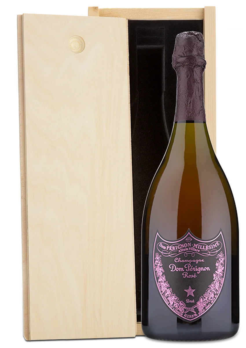 A Dom Perignon Rosé Champagne bottle displayed in a wooden wine box.
