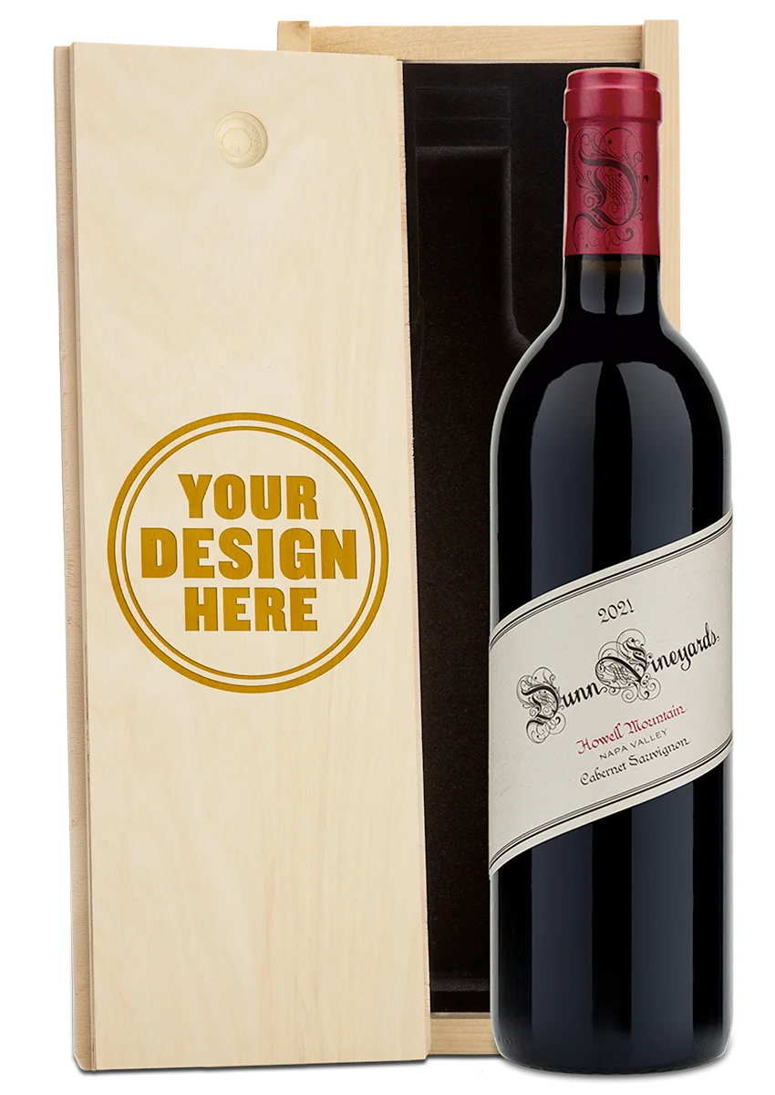 A bottle of 2021 Dunn Vineyards Howell Mountain Cabernet Sauvignon with a custom engraved wooden wine box.