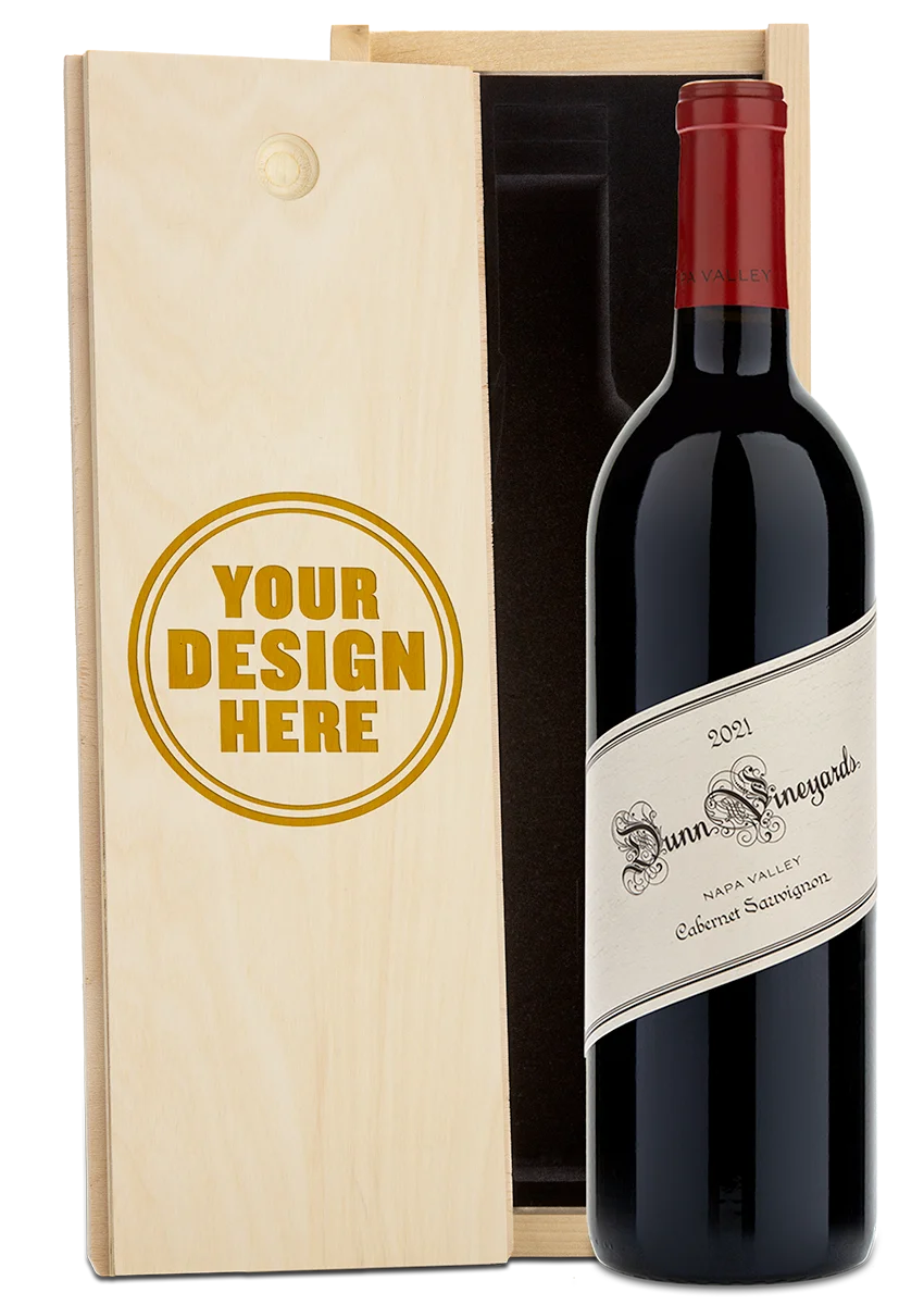 A bottle of 2021 Dunn Vineyards Napa Valley Cabernet Sauvignon with a custom engraved wooden wine box.