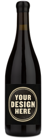 A dark glass wine bottle with a black label featuring a circular design placeholder that reads 'YOUR DESIGN HERE' in beige text, shown on a plain white background.